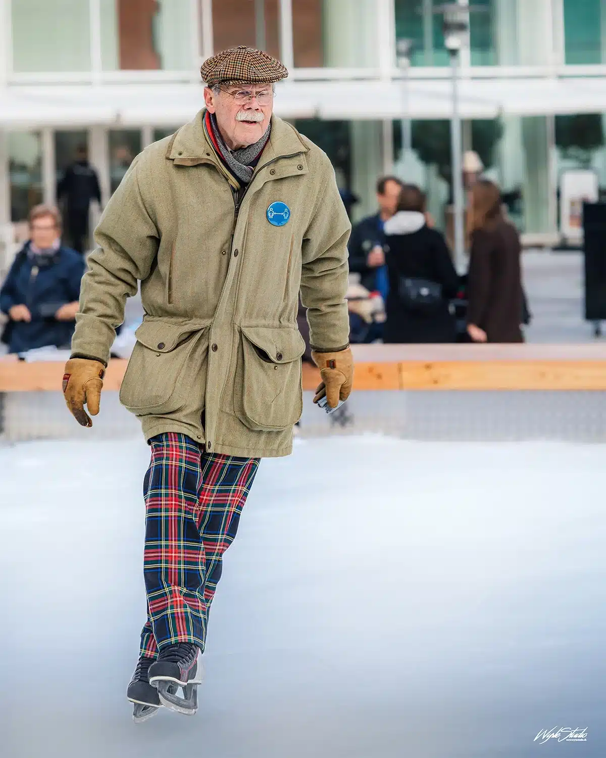 Ældre mand på isen i ternede bukser løber elegant på Skøjtebanen Musikhusparken