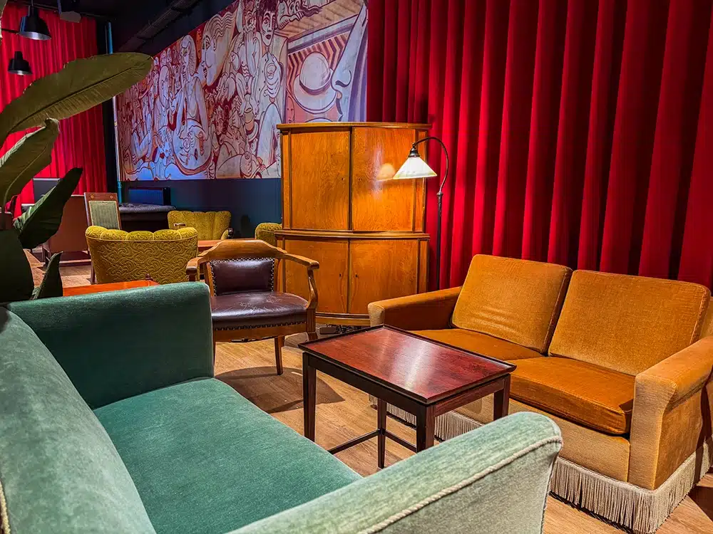 Farverige vintagemøbler og røde gardiner hos Porter’s i Aarhus